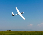 Glider flying on a blue sky