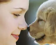 Woman Rubbing Noses with Puppy ca. 2002
