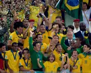 Brazil's forward Neymar raises the trophy as the team celebrates winning the FIFA Confederations Cup Brazil 2013 football tournament by defeating Spain 3-0 in the final, at the Maracana Stadium in Rio de Janeiro on June 30, 2013. AFP PHOTO / JUAN BARRETO