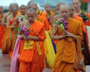 Thai buddhists walk around a statue to give homage Buddha during Asaha Bucha Day at Buddhamonthon, a suburb of Bangkok on July 15, 2011. Asaha Bucha is one of the most important festivals in the Buddhist calendar and celebrates the occasion of the first sermon given by the Lord Buddha. AFP PHOTO / PORNCHAI KITTIWONGSAKUL