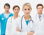 Confident professional doctors standing in hospital over white background