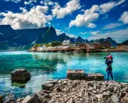 Nature photographer tourist with camera shoots Lofoten archipelago islands Norway. Beautiful Nature